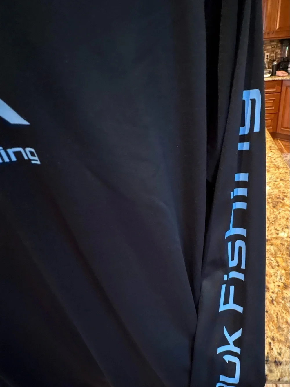 Huk men’s long sleeve performance Fishing Shirt. Sharp Black with blue logos.